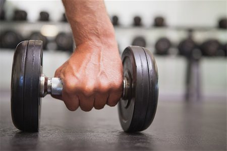 simsearch:400-07103428,k - Fit man lifting heavy black dumbbell at the gym Photographie de stock - Aubaine LD & Abonnement, Code: 400-07926076