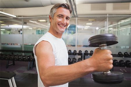 simsearch:400-08017381,k - Fit man lifting heavy black dumbbell at the gym Photographie de stock - Aubaine LD & Abonnement, Code: 400-07926081