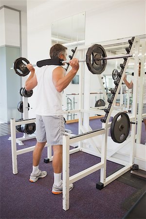 simsearch:400-07103428,k - Fit man lifting heavy barbell at the gym Photographie de stock - Aubaine LD & Abonnement, Code: 400-07926105