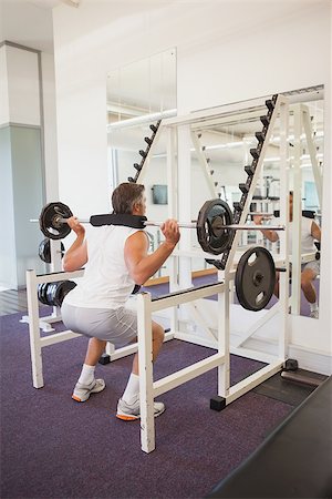 simsearch:400-07103428,k - Fit man lifting heavy barbell at the gym Photographie de stock - Aubaine LD & Abonnement, Code: 400-07926106