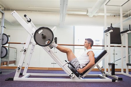 simsearch:400-07103428,k - Fit man lifting heavy barbell with legs at the gym Photographie de stock - Aubaine LD & Abonnement, Code: 400-07926109