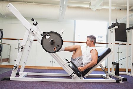 simsearch:400-07103428,k - Fit man lifting heavy barbell with legs at the gym Photographie de stock - Aubaine LD & Abonnement, Code: 400-07926110