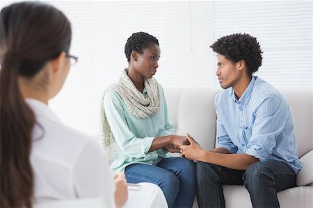 Reconciled couple smiling at each other in therapists office Stock Photo - Budget Royalty-Free & Subscription, Code: 400-07926271