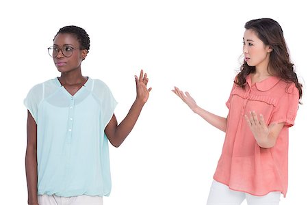 simsearch:400-06687238,k - Female friends having a disagreement on white background Fotografie stock - Microstock e Abbonamento, Codice: 400-07926492