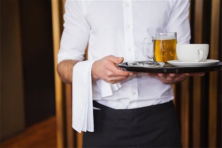 standing coffee bar - Smiling waiter holding tray with coffee cup and pint of beer in a bar Stock Photo - Budget Royalty-Free & Subscription, Code: 400-07926545