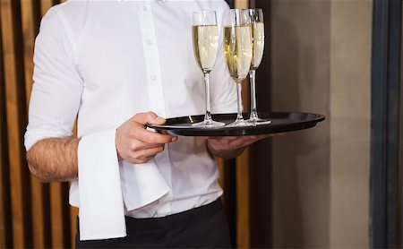 simsearch:6109-07601180,k - Waiter holding tray of champagne in a bar Stock Photo - Budget Royalty-Free & Subscription, Code: 400-07926546