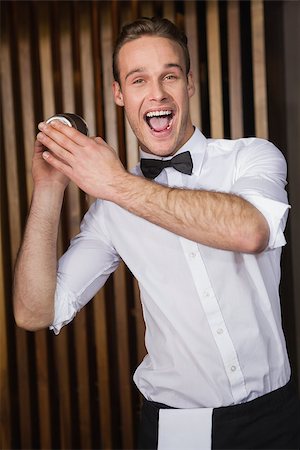 drink shaker - Happy waiter shaking drink in cocktail shaker in a bar Stock Photo - Budget Royalty-Free & Subscription, Code: 400-07926562