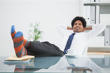 Businessman relaxing in his swivel chair with feet up in his office Stock Photo - Budget Royalty-Free & Subscription, Code: 400-07926789