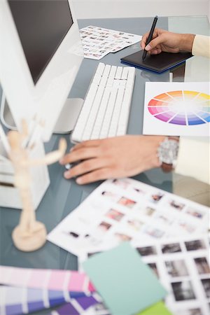 simsearch:400-07926810,k - Designer working at desk using digitizer in his office Fotografie stock - Microstock e Abbonamento, Codice: 400-07926799