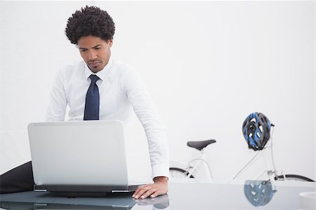 simsearch:400-07926810,k - Serious businessman sitting and using laptop in his office Fotografie stock - Microstock e Abbonamento, Codice: 400-07926792