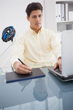 simsearch:400-07926810,k - Concentrated designer using laptop and degitizer in his office Fotografie stock - Microstock e Abbonamento, Codice: 400-07926824