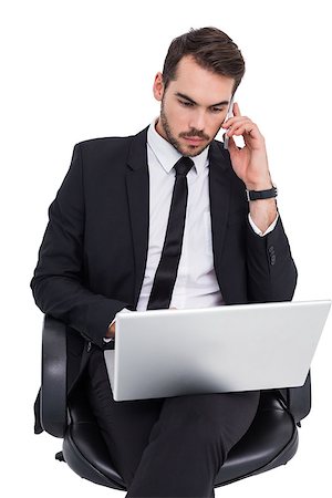 simsearch:400-07141019,k - Businessman using laptop while phoning on white background Stockbilder - Microstock & Abonnement, Bildnummer: 400-07927385