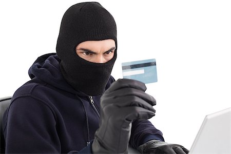 steal and card - Burglar using credit card and laptop on white background Stock Photo - Budget Royalty-Free & Subscription, Code: 400-07927559