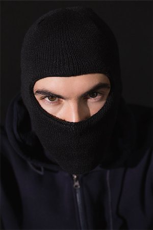 simsearch:400-06881880,k - Portrait of burglar wearing a balaclava on black background Stockbilder - Microstock & Abonnement, Bildnummer: 400-07927551