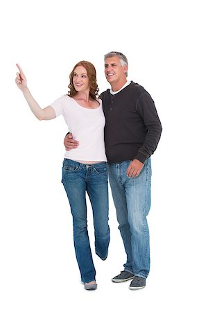 Casual couple walking and pointing on white background Stock Photo - Budget Royalty-Free & Subscription, Code: 400-07927580
