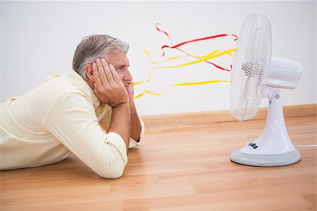 simsearch:400-07931092,k - Man lying on floor looking at fan at home in the living room Foto de stock - Super Valor sin royalties y Suscripción, Código: 400-07927834