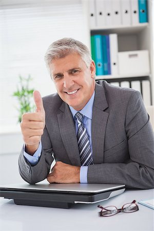 simsearch:400-07927898,k - Smiling businessman showing thumbs up in his office Stock Photo - Budget Royalty-Free & Subscription, Code: 400-07927845