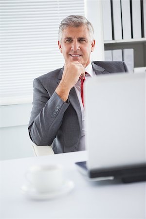 simsearch:400-06884500,k - Happy businessman at his desk in his office Stock Photo - Budget Royalty-Free & Subscription, Code: 400-07927884