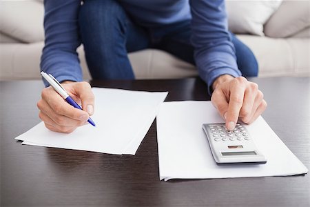 simsearch:400-07333928,k - Young man paying his bills at home in the living room Stock Photo - Budget Royalty-Free & Subscription, Code: 400-07927938