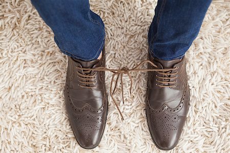 Classy mans shoelaces tied together  at home in the living room Stock Photo - Budget Royalty-Free & Subscription, Code: 400-07928004