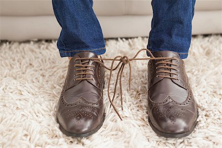 simsearch:400-07916242,k - Classy mans shoelaces tied together at home in the living room Foto de stock - Super Valor sin royalties y Suscripción, Código: 400-07928003