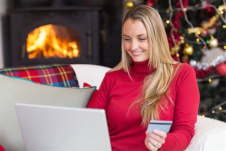 simsearch:400-07474252,k - Woman doing online shopping with laptop and credit card at home in the living room Stock Photo - Budget Royalty-Free & Subscription, Code: 400-07928081