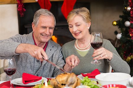 Man carving chicken while his wife drinking red wine at home in the living room Stock Photo - Budget Royalty-Free & Subscription, Code: 400-07928228