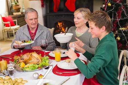 simsearch:400-07928326,k - Smiling extended family at the christmas dinner table at home in the living room Photographie de stock - Aubaine LD & Abonnement, Code: 400-07928248