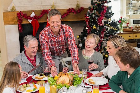 simsearch:400-06871551,k - Man serving roast turkey at christmas at home in the living room Stock Photo - Budget Royalty-Free & Subscription, Code: 400-07928262