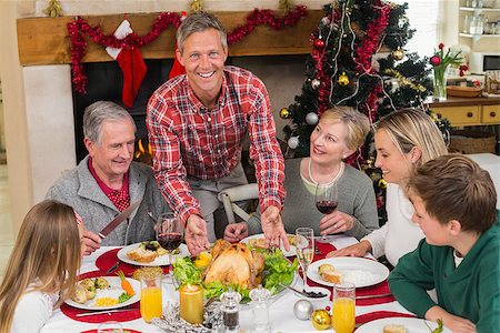 simsearch:400-06871551,k - Man serving roast turkey at christmas at home in the living room Stock Photo - Budget Royalty-Free & Subscription, Code: 400-07928263