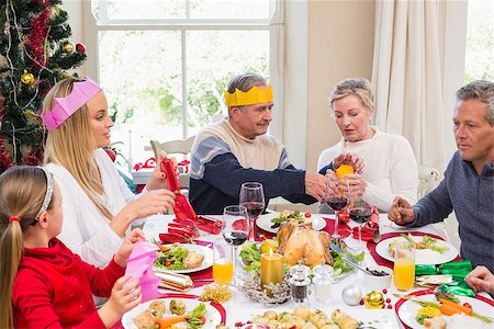 senior woman at christmas parties - Family in party hat having fun at christmas time at home in the living room Stock Photo - Budget Royalty-Free & Subscription, Code: 400-07928307