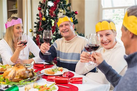 senior woman at christmas parties - Family in party hat toasting at christmas dinner at home in the living room Stock Photo - Budget Royalty-Free & Subscription, Code: 400-07928316