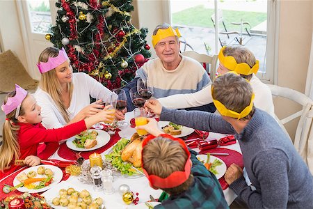 senior woman at christmas parties - Family in party hat toasting at christmas dinner at home in the living room Stock Photo - Budget Royalty-Free & Subscription, Code: 400-07928317