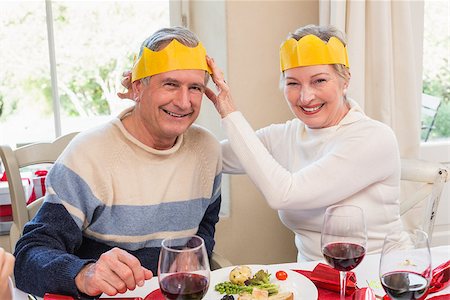 senior woman at christmas parties - Smiling mature couple in party hat at home in the living room Stock Photo - Budget Royalty-Free & Subscription, Code: 400-07928313