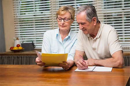 papers flat on table - Senior couple working out their bills at home in the kitchen Stock Photo - Budget Royalty-Free & Subscription, Code: 400-07928405