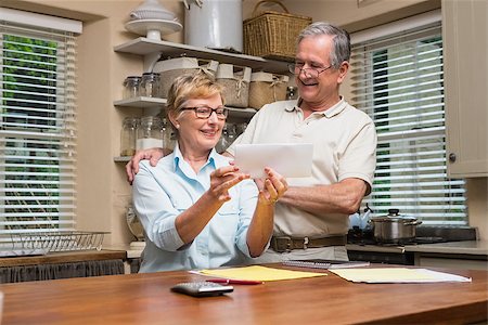 papers flat on table - Senior couple working out their bills at home in the kitchen Stock Photo - Budget Royalty-Free & Subscription, Code: 400-07928410