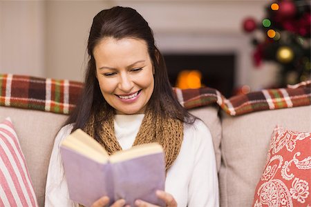 simsearch:6109-06194272,k - Pretty brunette reading book at christmas time at home in the living room Stock Photo - Budget Royalty-Free & Subscription, Code: 400-07928738