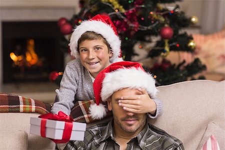simsearch:6109-07601570,k - Son surprising his father with christmas gift at home in the living room Stockbilder - Microstock & Abonnement, Bildnummer: 400-07928730