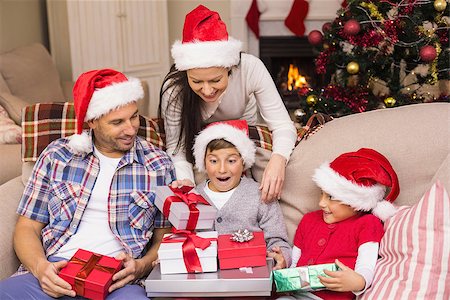 simsearch:6109-07601570,k - Surprised son opening his gifts on the couch at home Stockbilder - Microstock & Abonnement, Bildnummer: 400-07928768