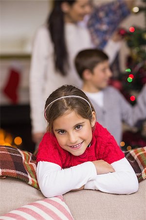 decorating small xmas tree - Cute little girl leaning on the couch while her family decorating the christmas tree Stock Photo - Budget Royalty-Free & Subscription, Code: 400-07928777