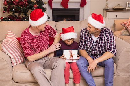 simsearch:400-07929054,k - Three generation family celebrating christmas at home in the living room Stock Photo - Budget Royalty-Free & Subscription, Code: 400-07928878