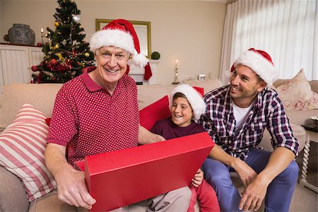 simsearch:400-07929054,k - Smiling grandfather opening his gift at home in the living room Stock Photo - Budget Royalty-Free & Subscription, Code: 400-07928882