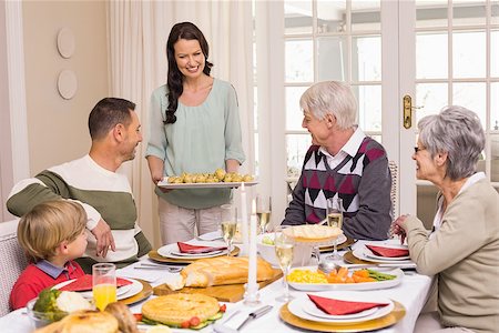 simsearch:400-07928327,k - Woman serving christmas dinner to her family at home in the living room Foto de stock - Super Valor sin royalties y Suscripción, Código: 400-07928915