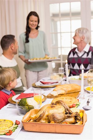 simsearch:400-07929054,k - Woman holding christmas dinner with family at dinning table at home in the living room Stock Photo - Budget Royalty-Free & Subscription, Code: 400-07928918