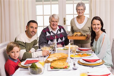 simsearch:400-06871551,k - Grandmother holding turkey roast with family at christmas at home in the living room Stock Photo - Budget Royalty-Free & Subscription, Code: 400-07928913