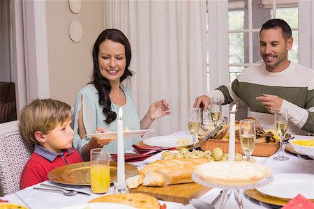 simsearch:400-07928326,k - Mother passing the plate to her son at home in the living room Photographie de stock - Aubaine LD & Abonnement, Code: 400-07928935