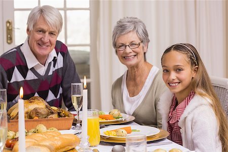 simsearch:400-07928326,k - Portrait of grandparents and daughter during christmas dinner at home in the living room Photographie de stock - Aubaine LD & Abonnement, Code: 400-07928949