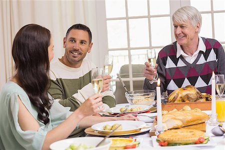 simsearch:400-07929054,k - Smiling family toasting during christmas dinner at home in the living room Stock Photo - Budget Royalty-Free & Subscription, Code: 400-07928954