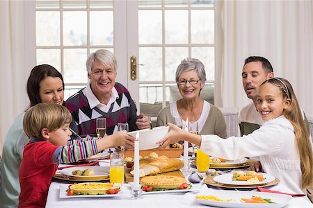 simsearch:400-07928326,k - Smiling extended family at the christmas dinner table at home in the living room Photographie de stock - Aubaine LD & Abonnement, Code: 400-07928966