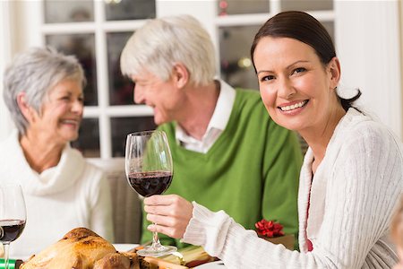 simsearch:400-07929054,k - Portrait of woman toasting at camera during christmas dinner at home in the living room Stock Photo - Budget Royalty-Free & Subscription, Code: 400-07928988